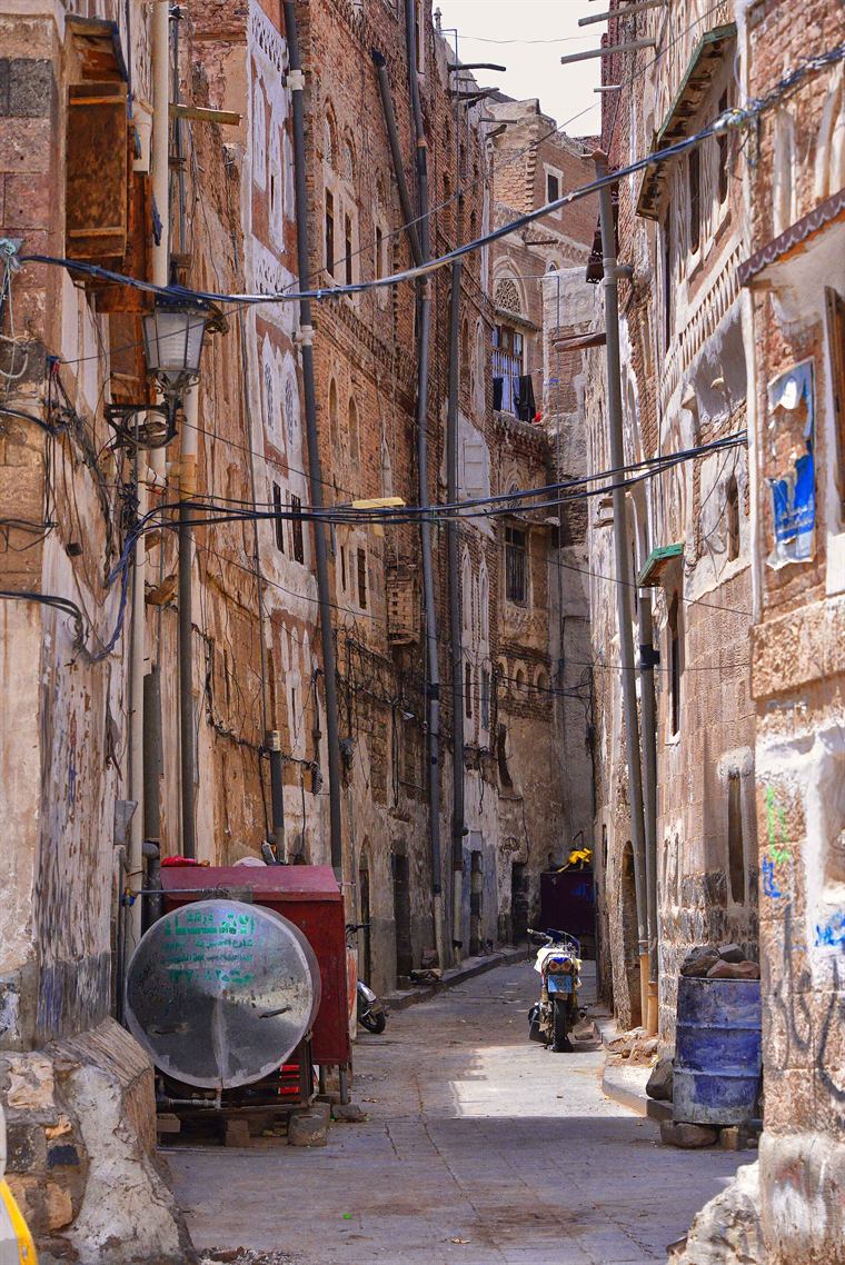 A brick alley behind the block face